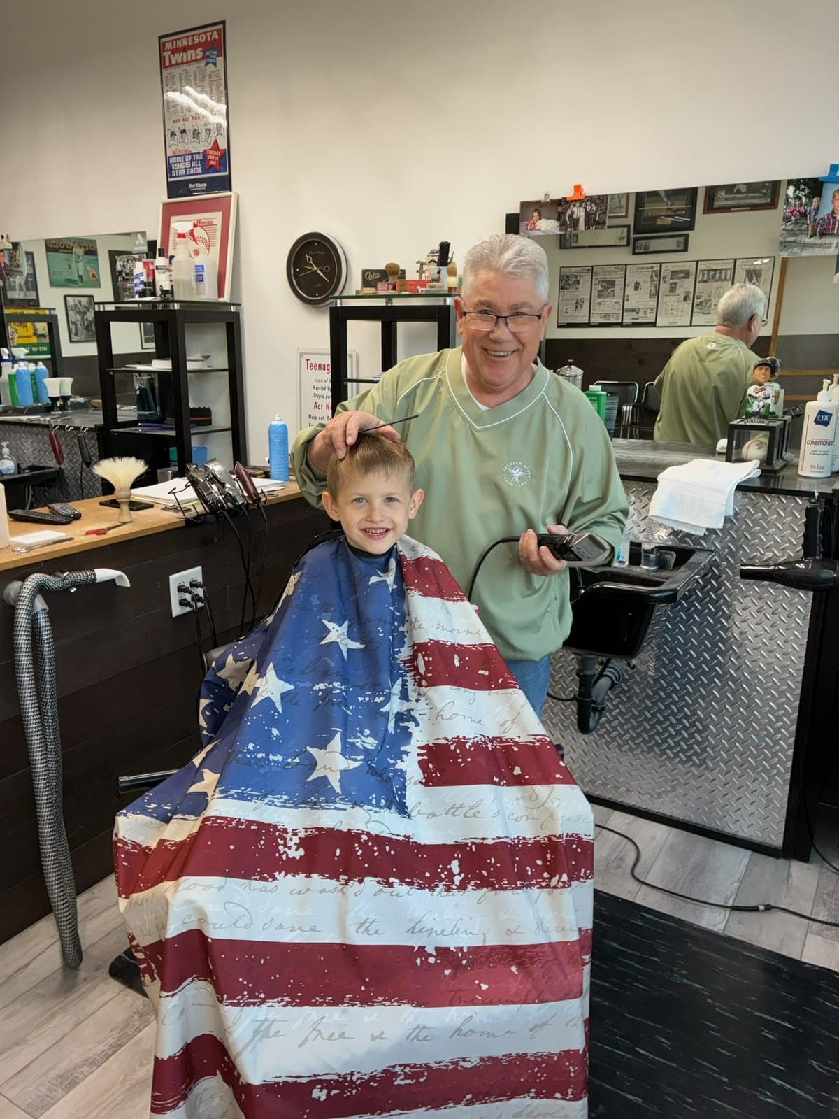 Barber with a young customer at Kenyon Barber Shop